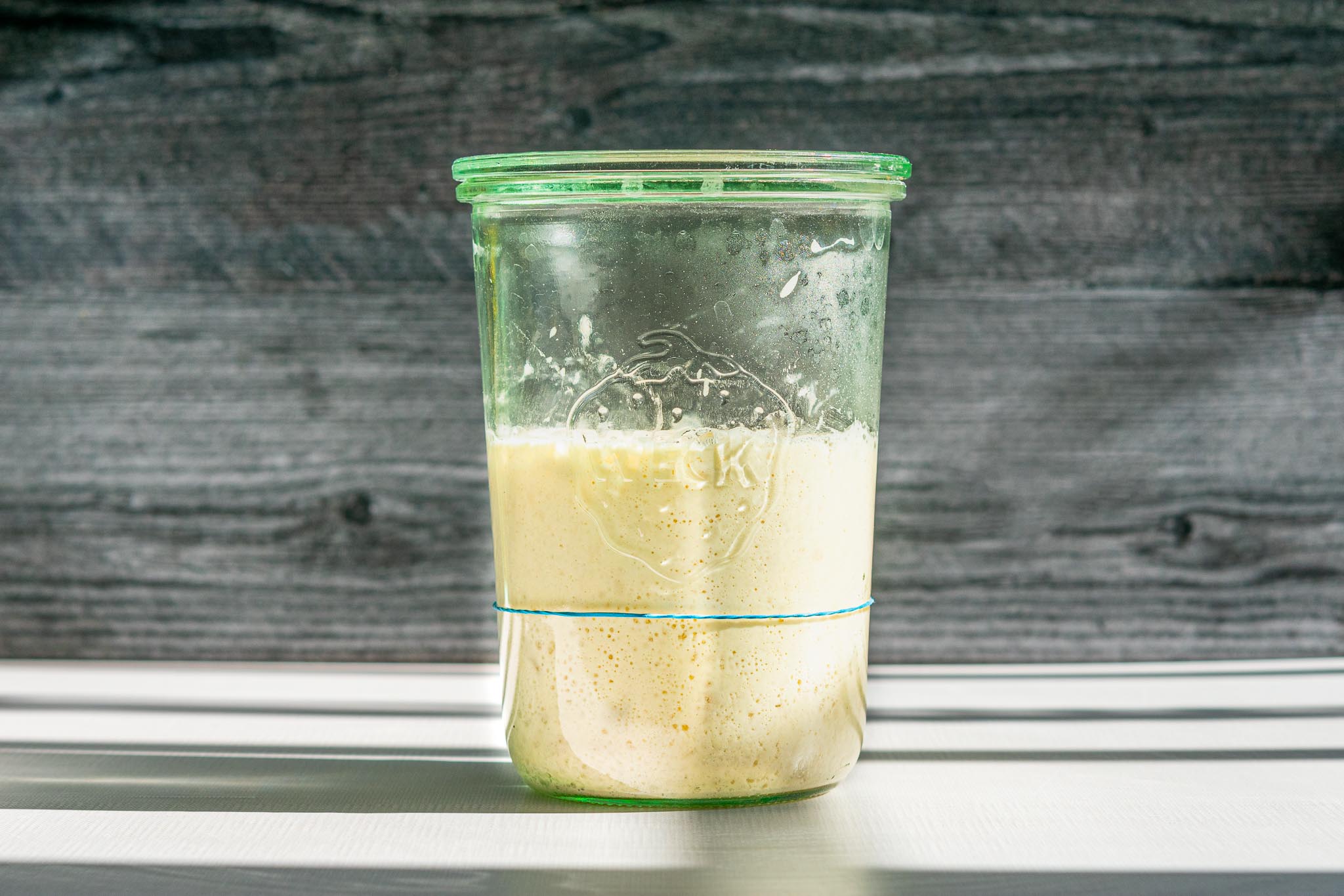 image of a glass jar containing sourdough starter