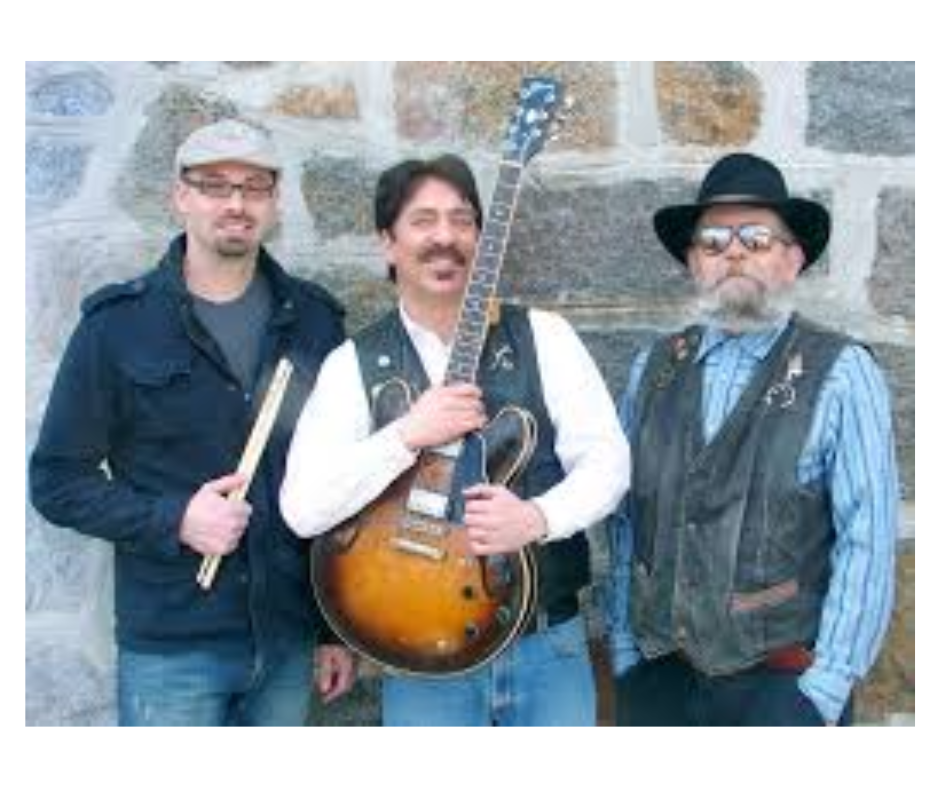 image of three men standing in front of a stone wall. one is holding a steel guitar and one is holding drumsticks