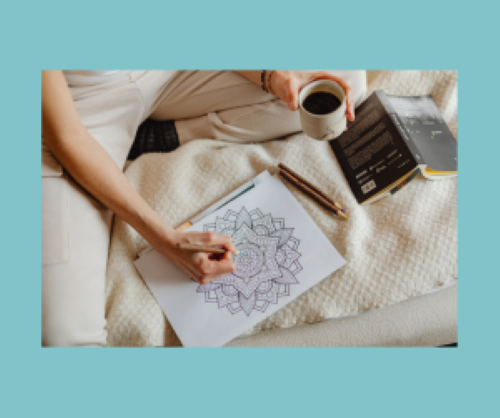 Coloring on bed with a coffee