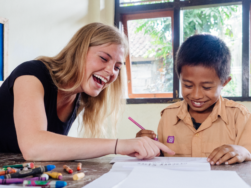 Teen Tutoring a Child